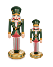 Two decorative inflatable nutcrackers with green hats and striped pants on a white background